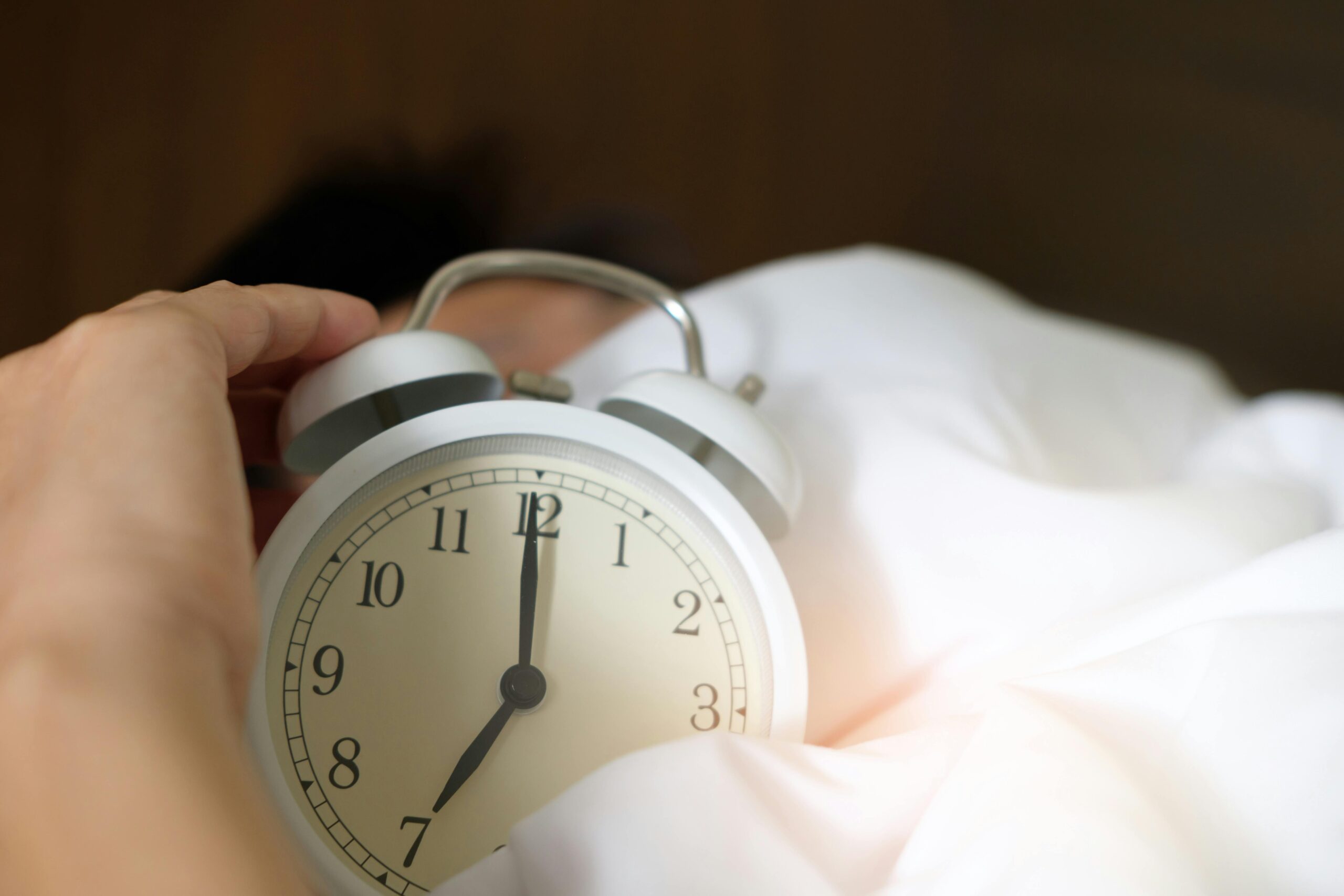 hand reaching for clock